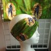 14.5Bandeau en tissu Wax et Madras aux couleurs orangées et verdoyantes sur une combinaison de deux pièces. Confectionné par Anjero Création.