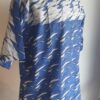 9.3Chemise en tissu coton wax assortie d'un imprimé montrant des formes de vagues océaniques sur fond bleu et inversé sur fond blanc. Ce modèle est conçu en manches courtes. Une fermeture éclaire à bout fermé subtilement dissimulée est ajoutée sur l'épaule gauche. Elle est faite de nylon souple et d'une tête de fermeture à glissière en métal, solide et durable. La dent de la fermeture à glissière est lisse et ne s'accroche pas, ajoutant ainsi, une touche attractive et supplémentaire à la confection. Taille unique. Ce produit est entièrement confectionné en atelier, en série limitée, par AnjeroCréation.