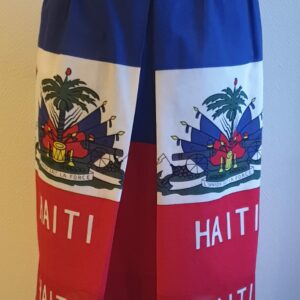 1.1Jupe longue en rouge et bleue avec de chaque côtés le drapeau haïtien. Un grand pli creux suivi des fronces se dessine à l'avant et l'arrière de ce modèle entièrement conçu et réalisé par les ateliers AnjeroCréation à Paris. Taille : S,M, L, XL, XXL. Prix : 79.59€
