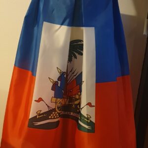 4.1Jupe très longue et plissée en rouge et bleue, avec au centre le grand drapeau haïtien. Le tissu de ce modèle est en polyester. Taille : S, M, L, Xl, XXL. Entièrement conçu et réalisé par les ateliers AnjeroCréation à Paris. Prix : 79.95€