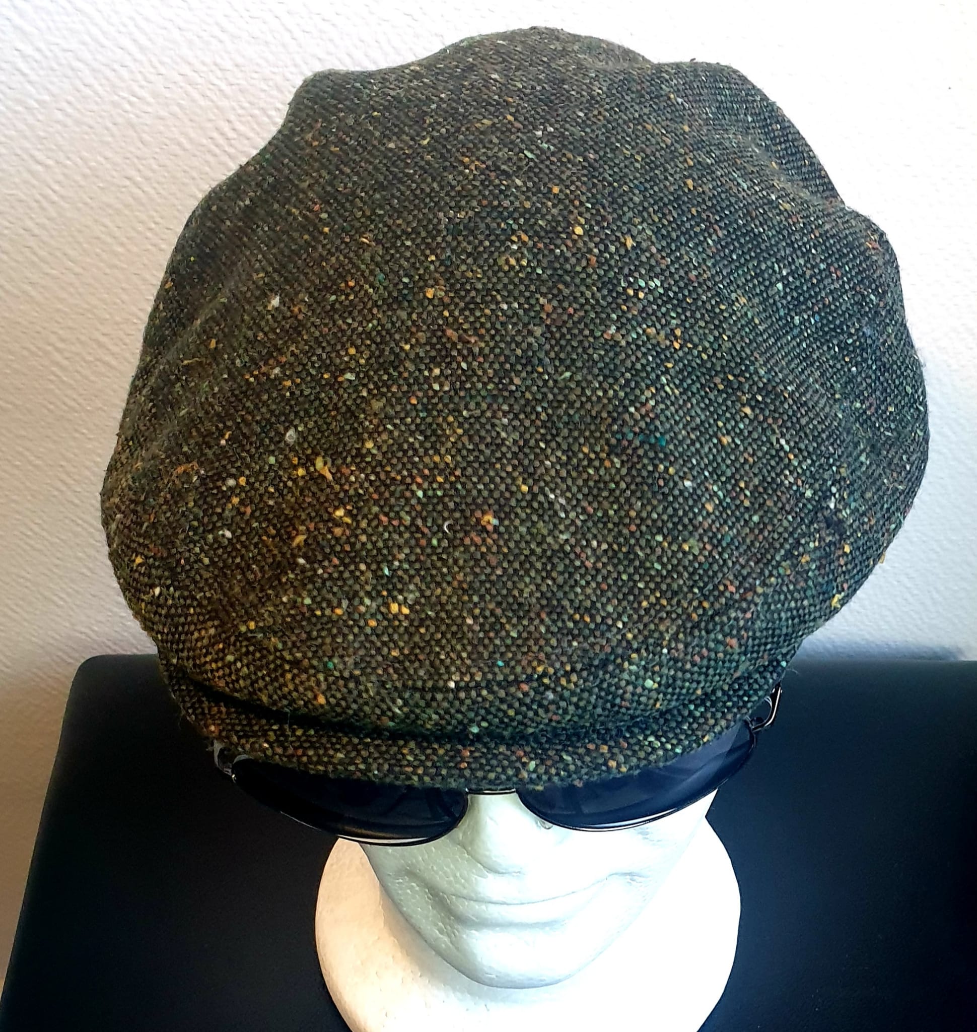 4.4Béret en vert moucheté entièrement doublé avec un dessus de calotte composé de laine. Le fond de calotte en polyester est matelassé en noir. Ce couvre-chef a été confectionné en Italie. Toutes les tailles de tour de tête sont disponibles. Prix : 27.50€.