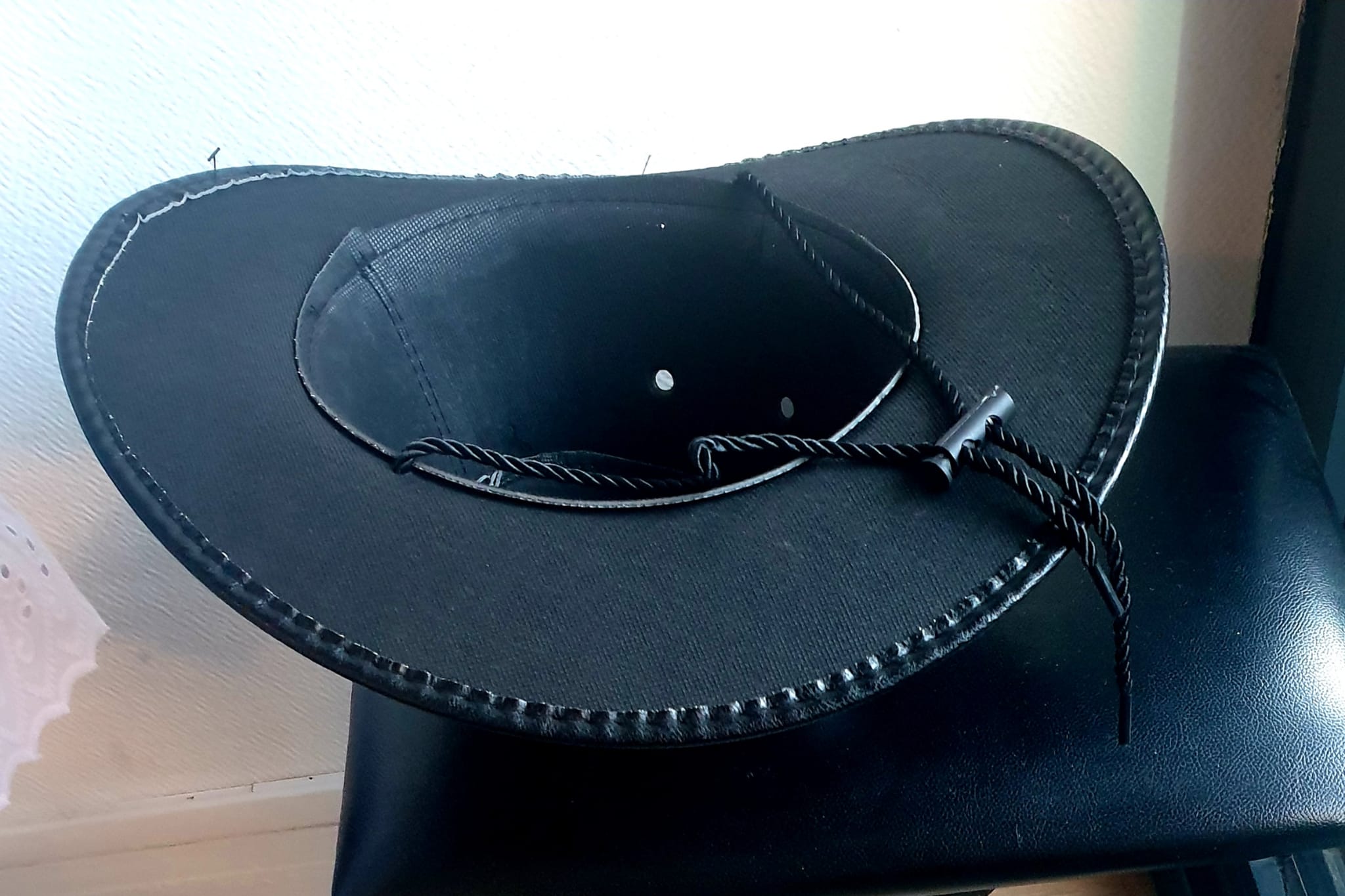 17.2Chapeau cowboy large bord en noir et en PVC ajoute un effet simili cuir. Un cordon de serrage noir en coton permet un bon maintien et assure une possible inclinaison sur l'arrière cou sans détachement. Un style très original et typique lui est conféré. Prix : 19.95€.