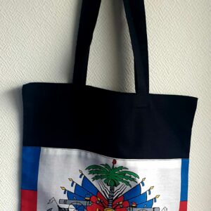 1.1Tote-bag en coton sur un extérieur bleu rouge orné du drapeau haïtien. Son intérieur est tout en noir. Ce produit es muni d'une élégante anse de bonne hauteur aux fins de facilité son port. Entièrement conçu et réalisé aux ateliers AnjeroCréation à Paris. Prix : 19,95€.